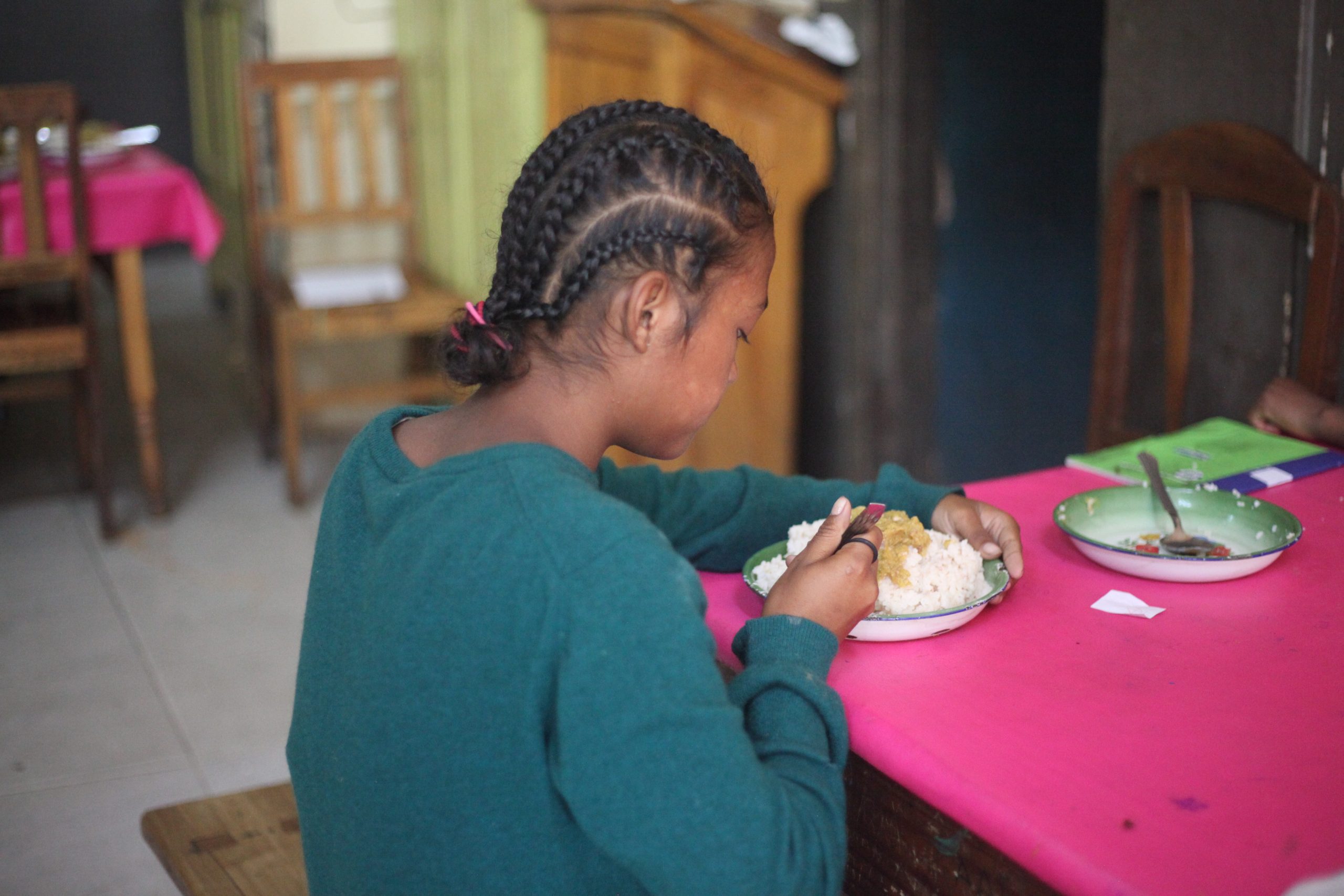 A girl eating a meal at one of Money for Madagascar's children's centres